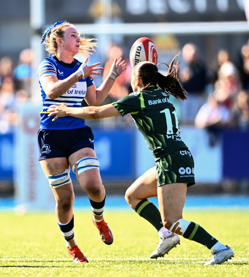 Leinster flanker Aoife Corcoran offloads under pressure from Connacht's Emily Foley