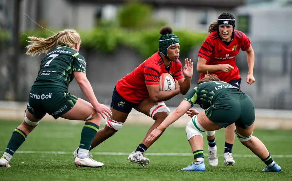 Grace Moore takes on Connacht's Ailish Quinn and Poppy Garvey