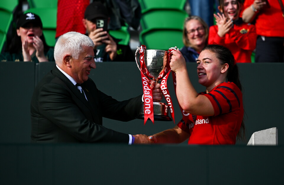 IRFU President Tony O'Beirne presents the trophy to Munster's Maeve Óg O'Leary