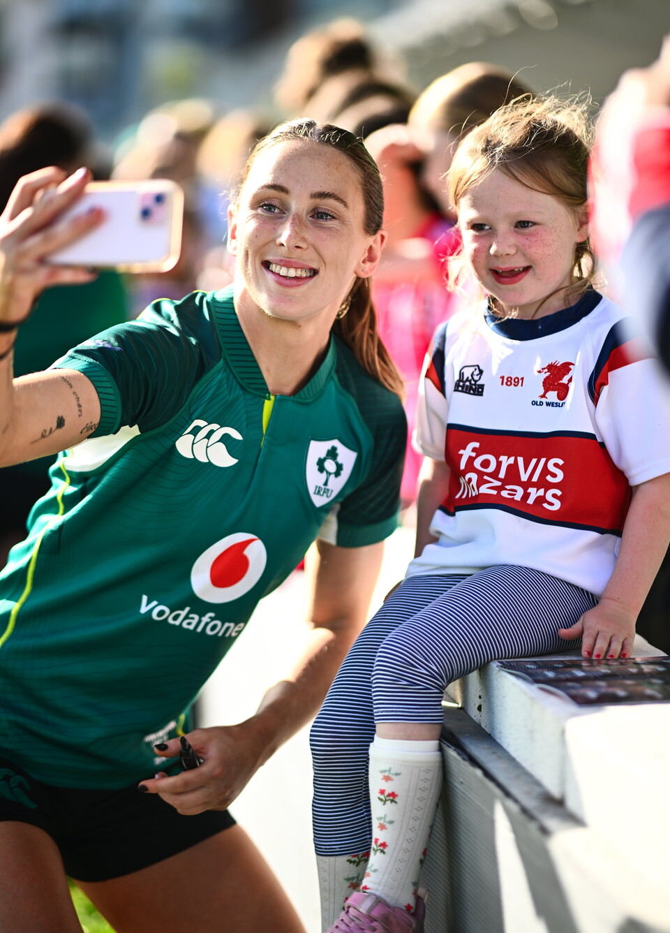 Anna McGann takes a selfie with a young fan