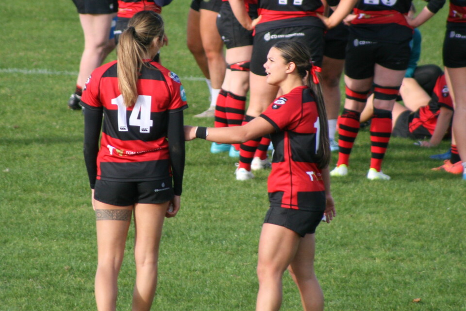 Caitlyn and Takiah chatting on the pitch