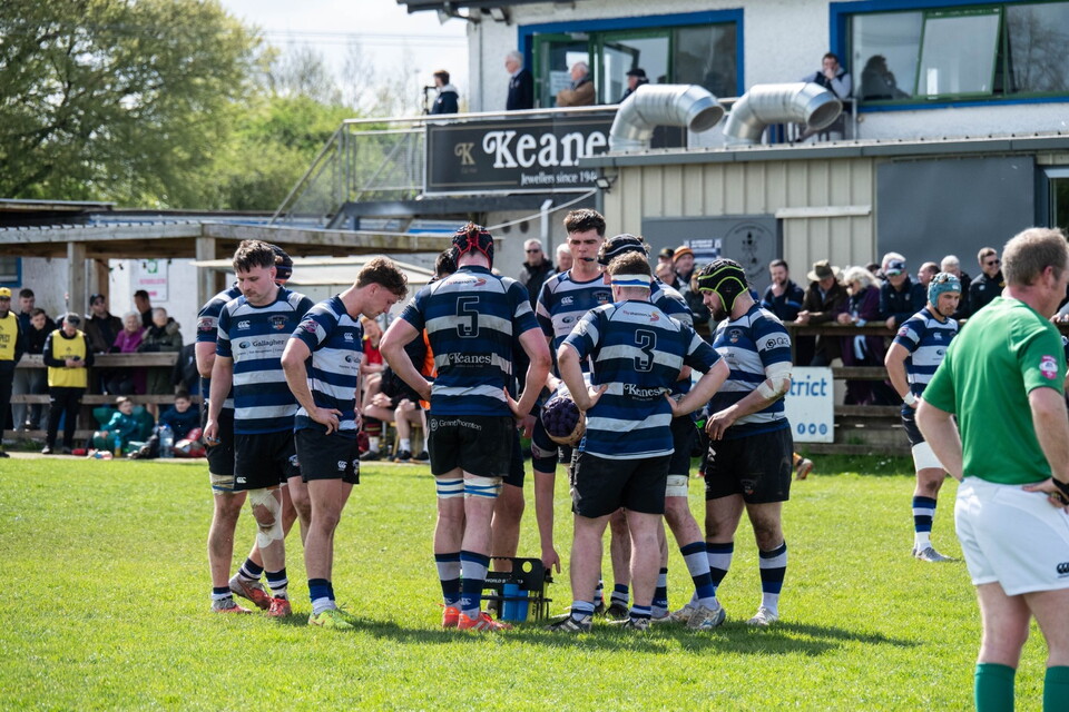 Old Crescent players huddle during a game
