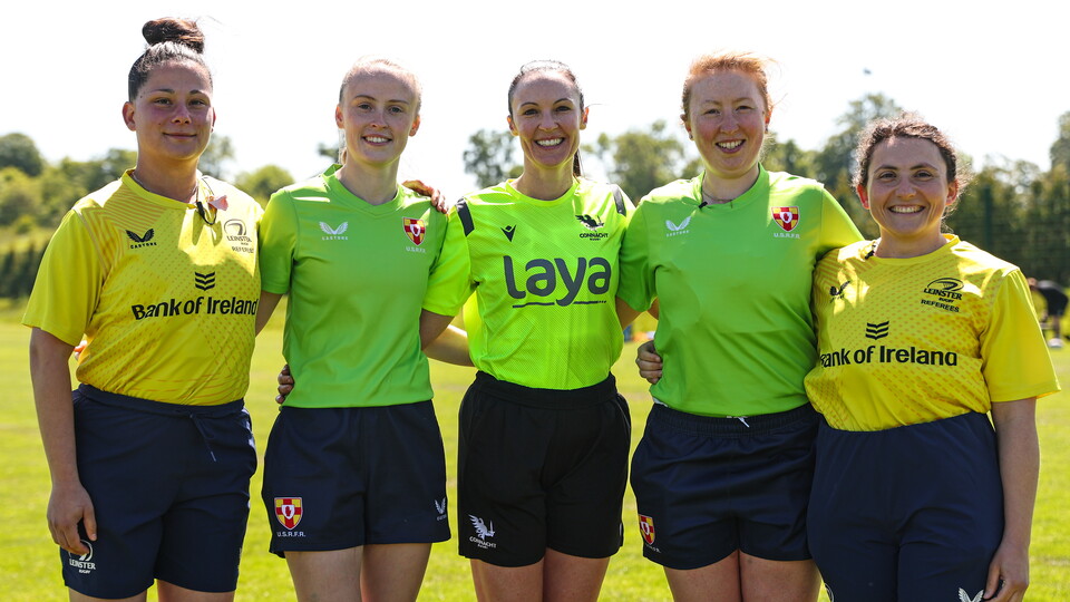 A group shot of five female referees