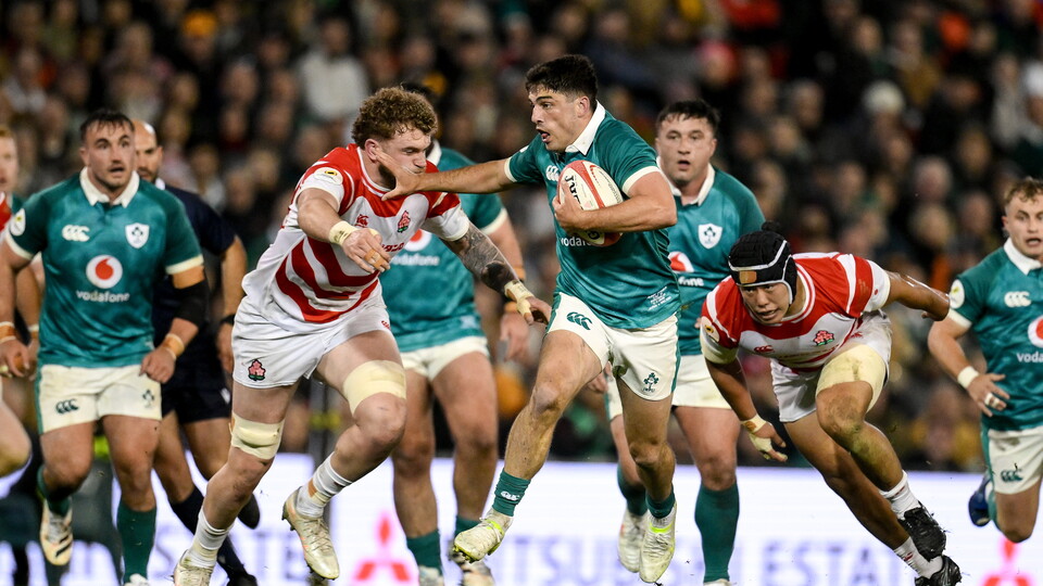 Jimmy O'Brien tries to break past Japan's Warner Dearns
