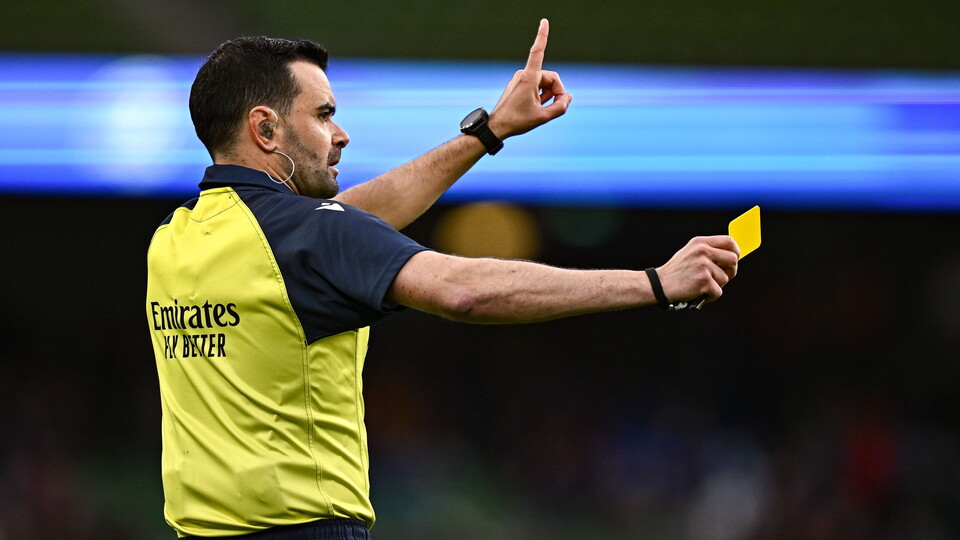 Referee giving a yellow card