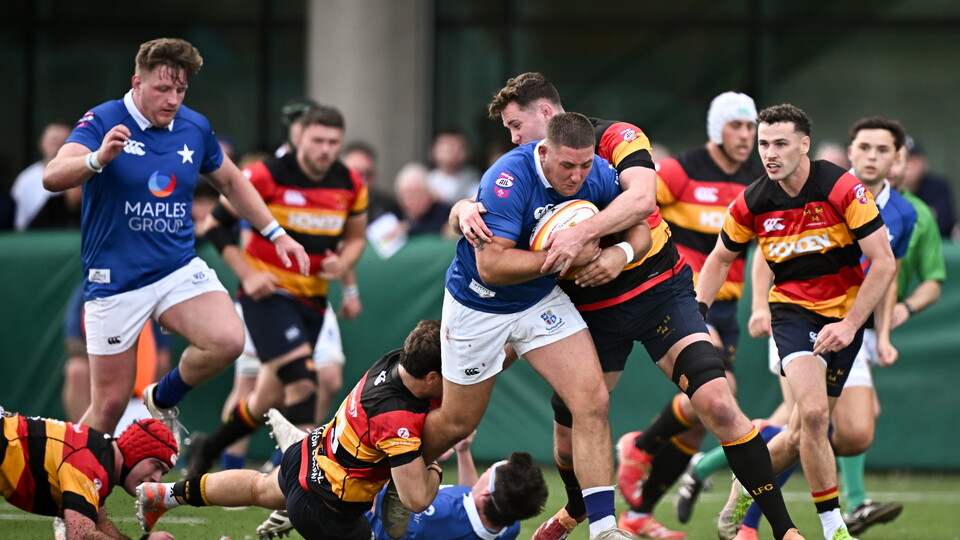 Dan Goggin drives forward for St. Mary's College against Lansdowne