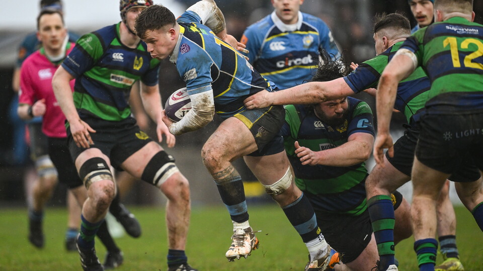 Dean Dillon of Dromore RFC is tackled by Callum Kavanagh of Seapoint RC
