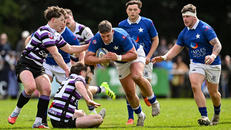 Dan Goggin of St Marys College RFC is tackled by Griffin Culver of Terenure College