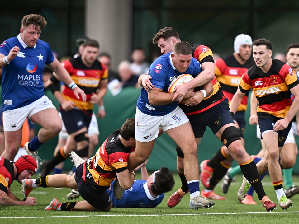 Dan Goggin drives forward for St. Mary's College against Lansdowne